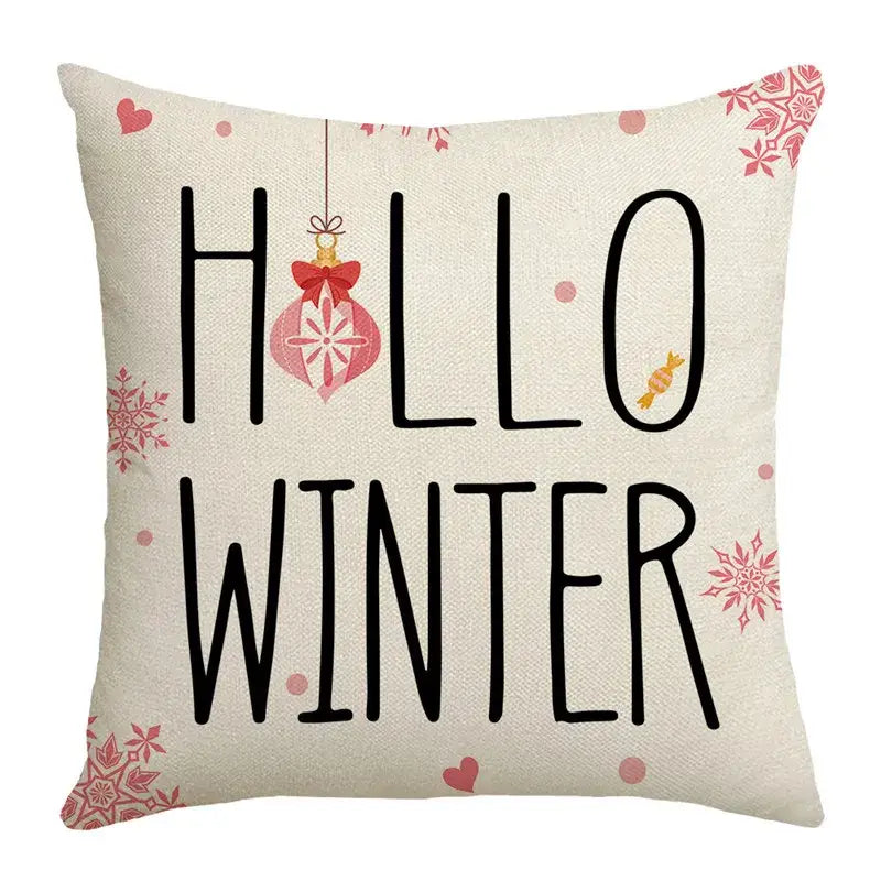 Beige linen pillow cover with hello winter text and pink snowflakes from decorbites christmas letter print collection