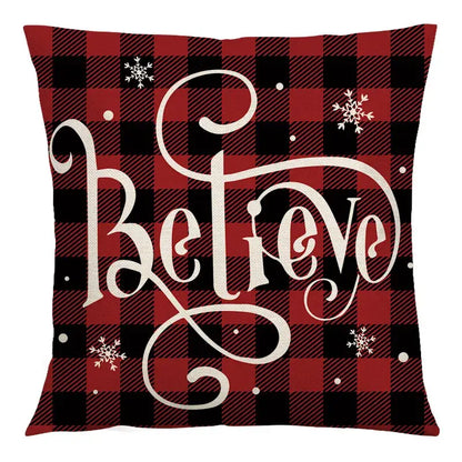 Red and black plaid cushion cover with white cursive believe lettering and snowflakes decorbites christmas linen cushion