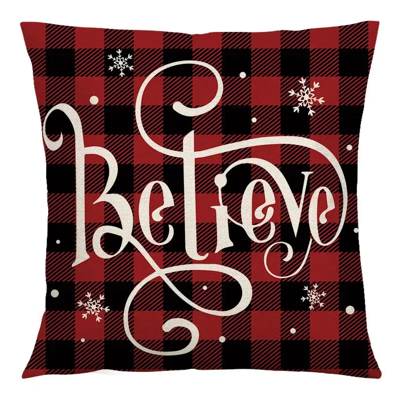 Red and black plaid cushion cover with white cursive believe lettering and snowflakes decorbites christmas linen cushion