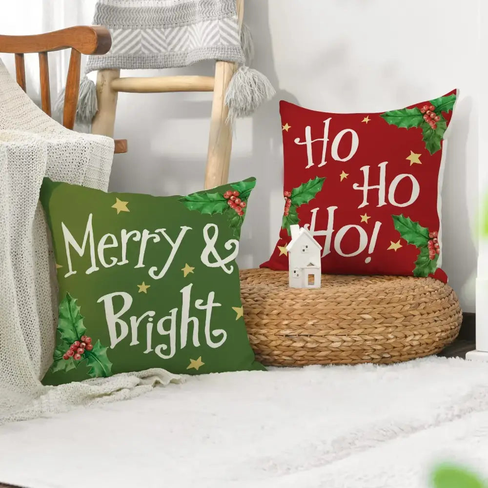 Green and red decorbites christmas linen decorative pillows with festive text holly berry accents and gold star details