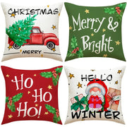 Four festive christmas linen decorative pillows with holiday prints including a red truck, merry and bright text, ho ho ho, and santa design