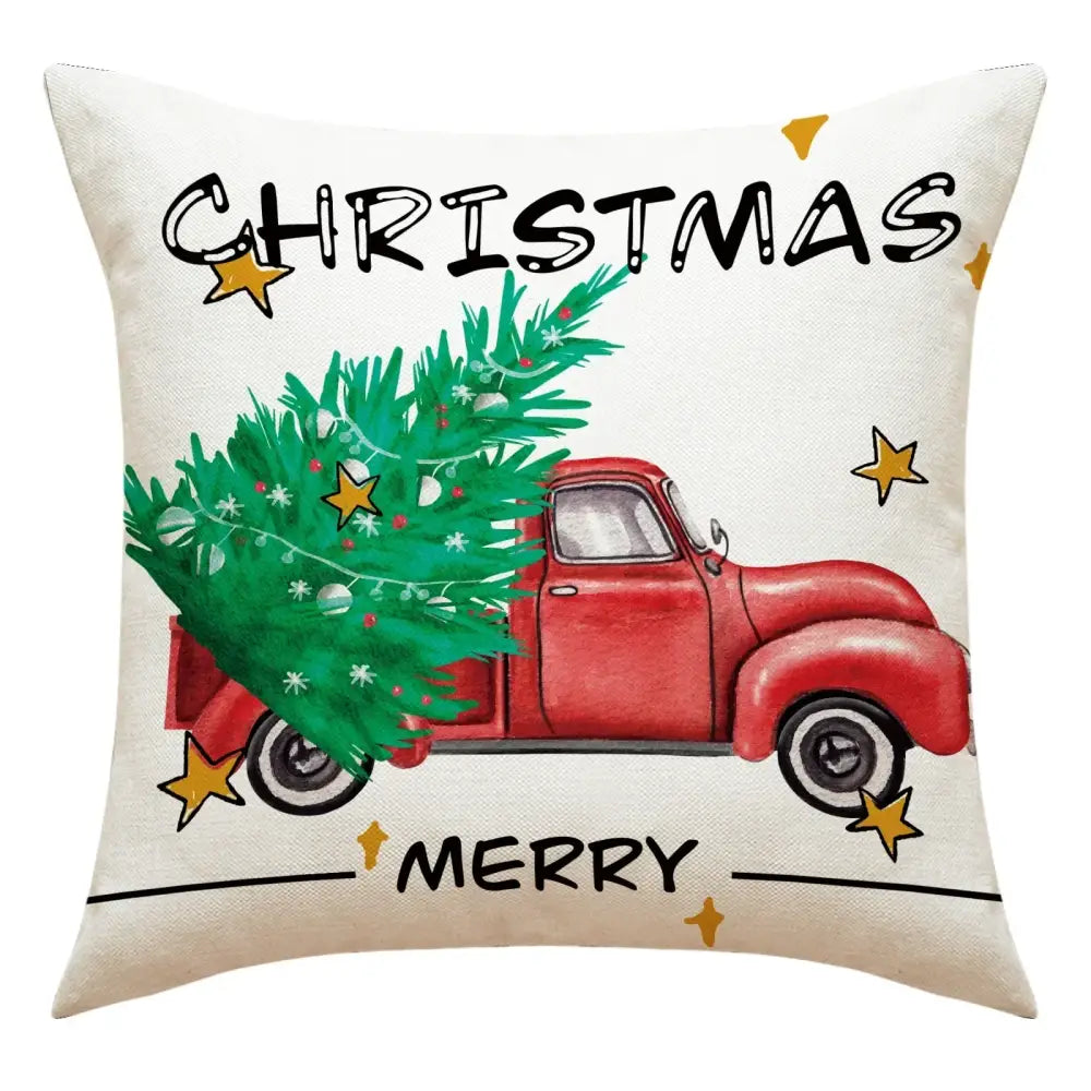 White linen decorative pillow featuring a red vintage truck with a green christmas tree and gold stars for christmas decor