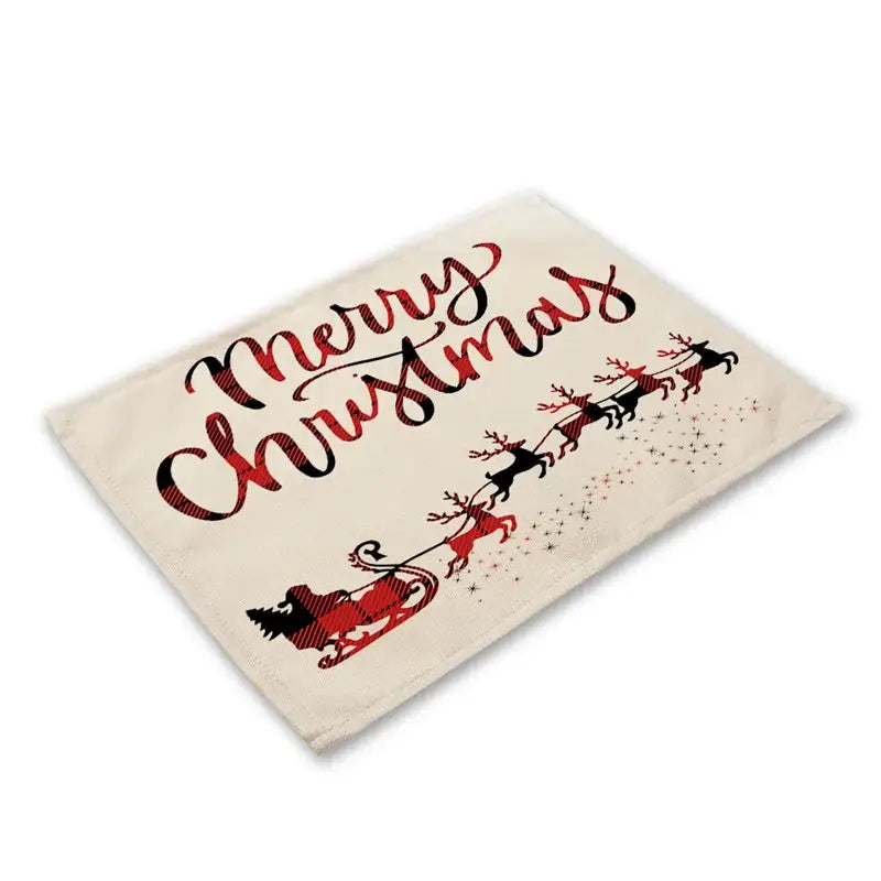 Cream-colored linen dining table mat with festive merry christmas design featuring red and black plaid reindeer and santa sleigh