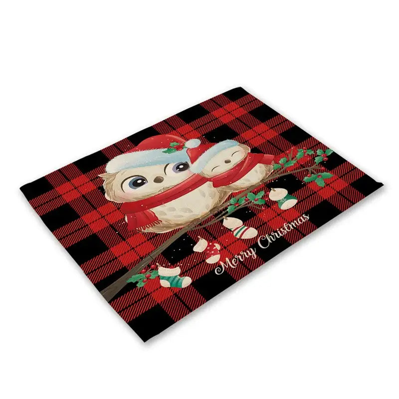 Red and black plaid christmas linen dining table mat with two owls wearing santa hats and merry christmas text cursive