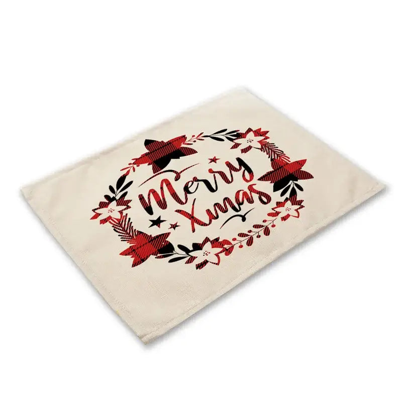 Cream-colored linen dining table mats featuring festive merry xmas design with red and black plaid holiday motifs