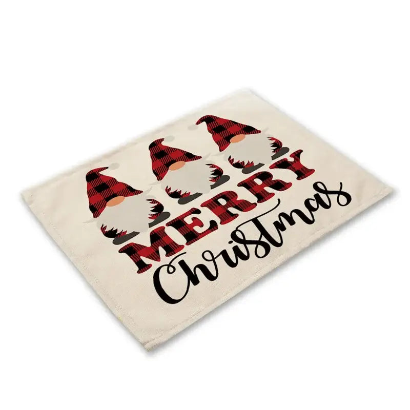 Cream-colored linen dining table mat with festive red and black plaid gnomes and merry Christmas script design