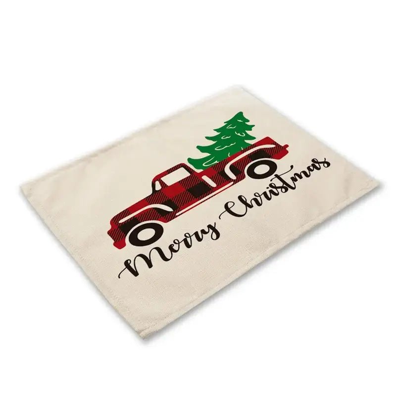 Beige linen dining table mat with red plaid truck carrying green christmas tree and merry christmas script