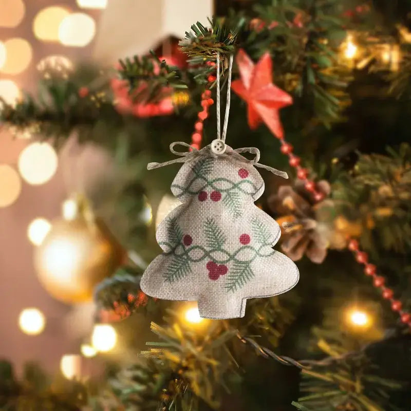 Beige linen printed pentagram sock ornament with green holly and red berries tied with rustic twine bow for christmas tree