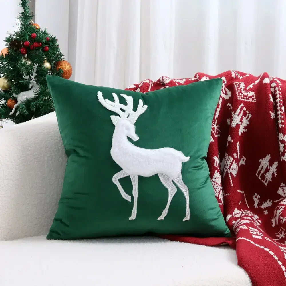 Deep green velvet cushion cover with white embroidered reindeer from decorbites christmas patchwork merrychristmas collection