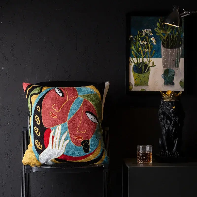 Vibrant embroidered cushion cover with stylized faces in red blue yellow and gold leaf accents decorbites christmas picasso style