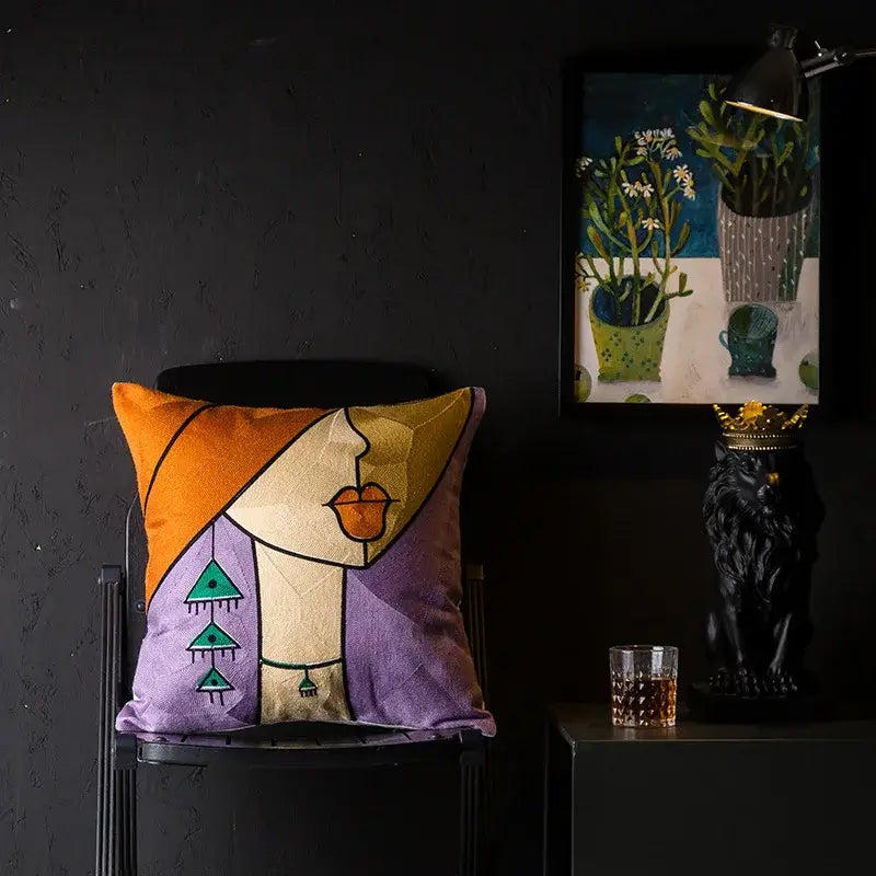 A vibrant embroidered cushion cover by decorbites christmas picasso featuring orange purple tones and teal patterns