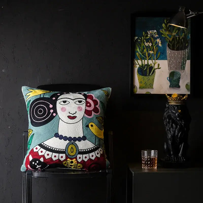 A vibrant decorbites christmas picasso style cushion cover with frida kahlo embroidery in teal red and black beadwork