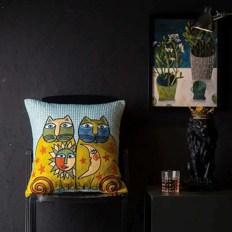 Vibrant yellow embroidered cushion cover with stylized cats and celestial faces on teal checkered background for living room decorbites christmas picasso style