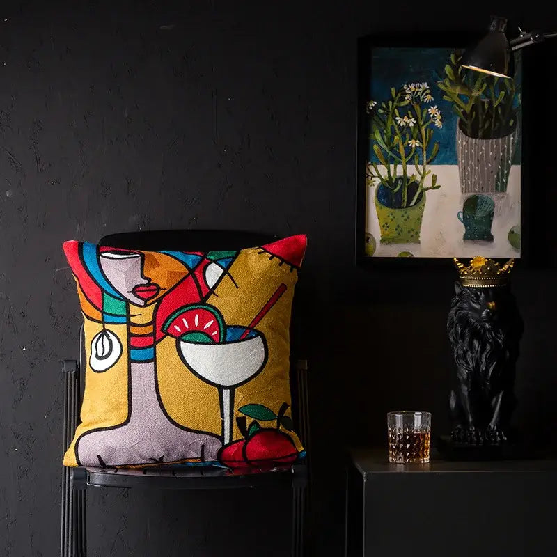 Vibrant embroidered cushion cover with colorful stylized portrait and abstract fruit in decorbites Christmas Picasso style