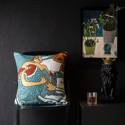 A square cushion cover with vibrant teal and cream embroidered stylized figures decorbites christmas picasso style