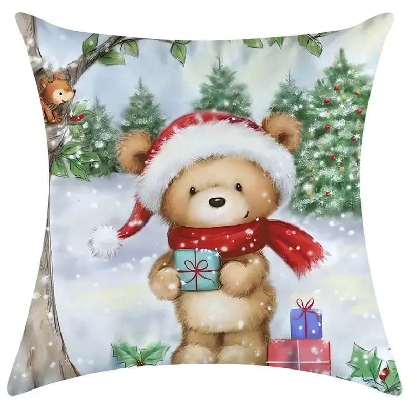 A cozy beige teddy bear wearing a red and white santa hat holding a gift on a decorbites christmas pillowcase