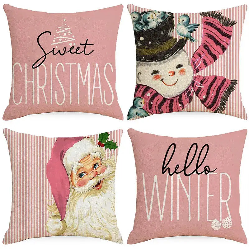 Set of four pink holiday-themed throw pillow covers featuring santa claus and snowman print for living room decor