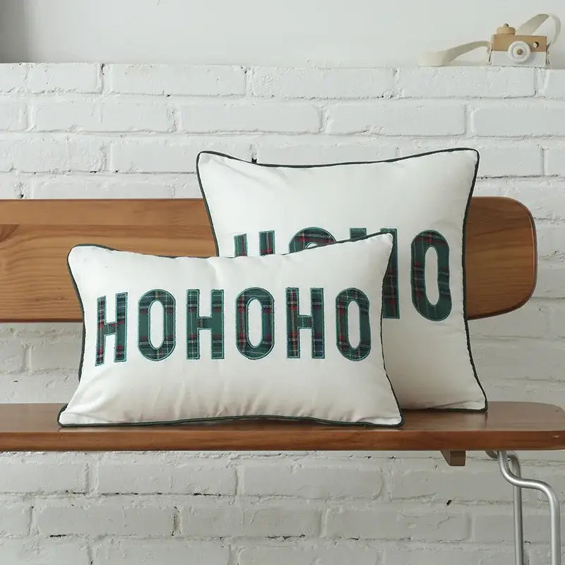 White rectangular cotton canvas cushion cover with hohoo in bold green plaid letters and black piping decorbites christmas plaid snowflake embroidery
