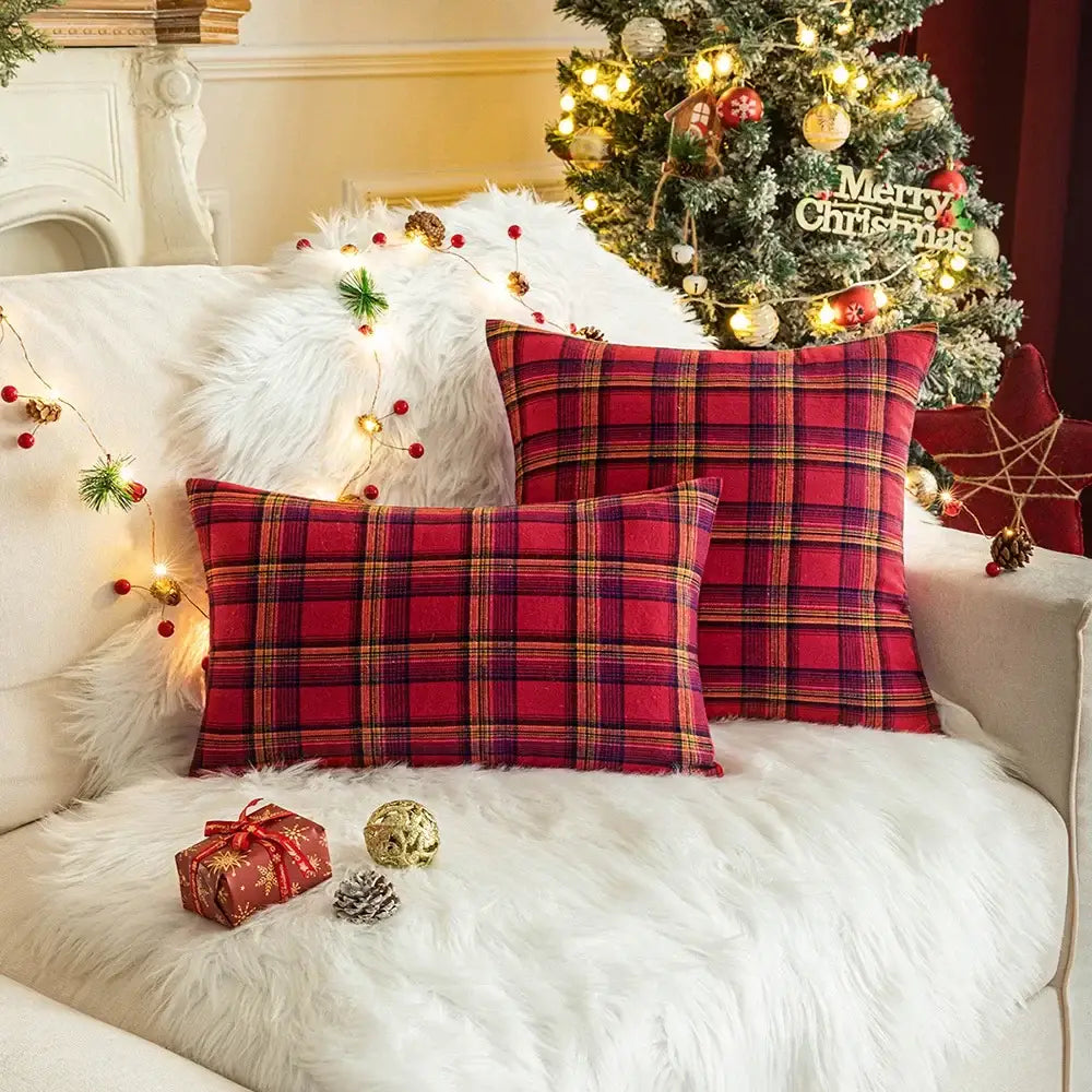 Red and black plaid christmas plaid cushion covers with gold trim on white fur couch by DecorBites christmas plaid