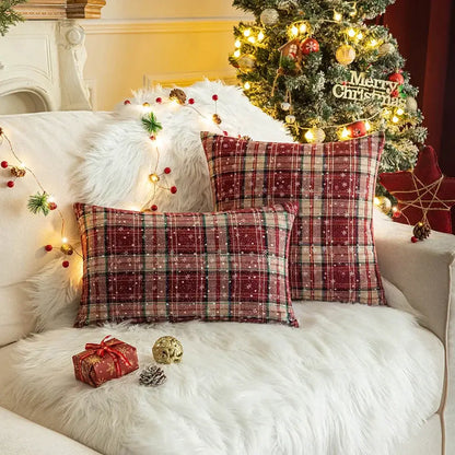 Red and beige decorbites christmas plaid cushion cover with subtle snowflake patterns on white fur sofa
