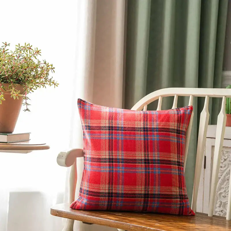 Red plaid cushion cover with intersecting blue and beige stripes on wooden chair for decorbites christmas plaid decor