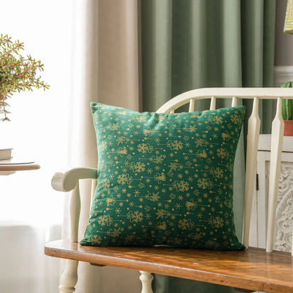 Emerald green decorbites christmas plaid cushion cover with gold snowflake and bee patterns on wooden bench