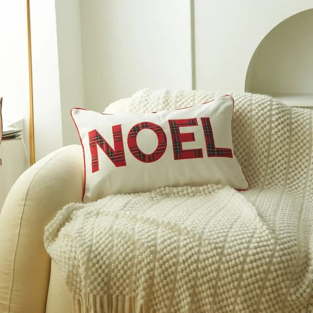 White rectangular pillow with red christmas plaid print noel lettering and red stitched border by decorbites christmas plaid