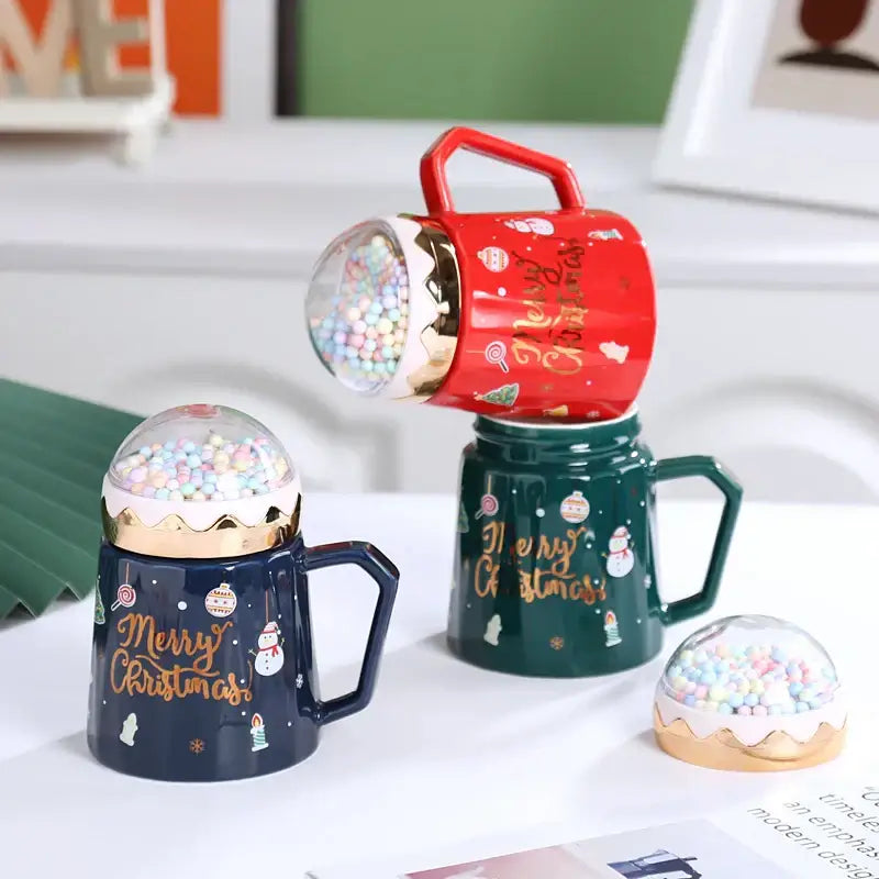 Red ceramic mug with gold trim and clear dome lid filled with colorful beads featured in decorbites christmas planet collection