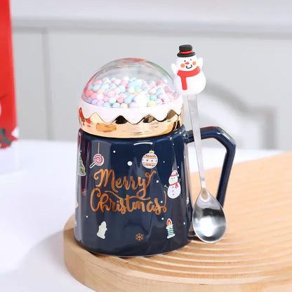 Navy blue ceramic mug with gold merry christmas script and clear dome lid filled with colorful candy spheres from decorbites christmas planet