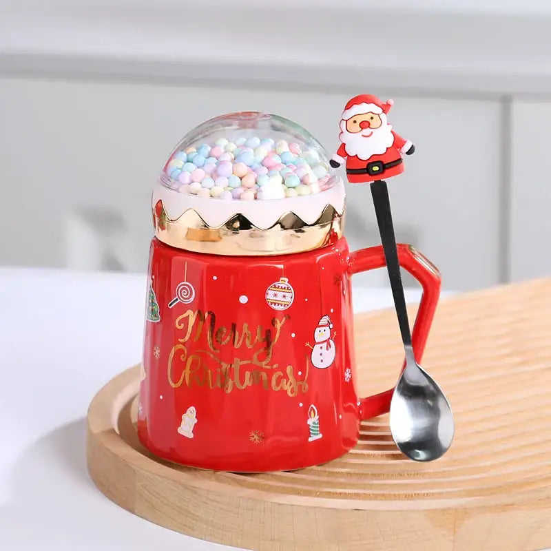 Red ceramic decorbites christmas planet ceramic mug with gold lettering lid and spoon topped with pastel marshmallows