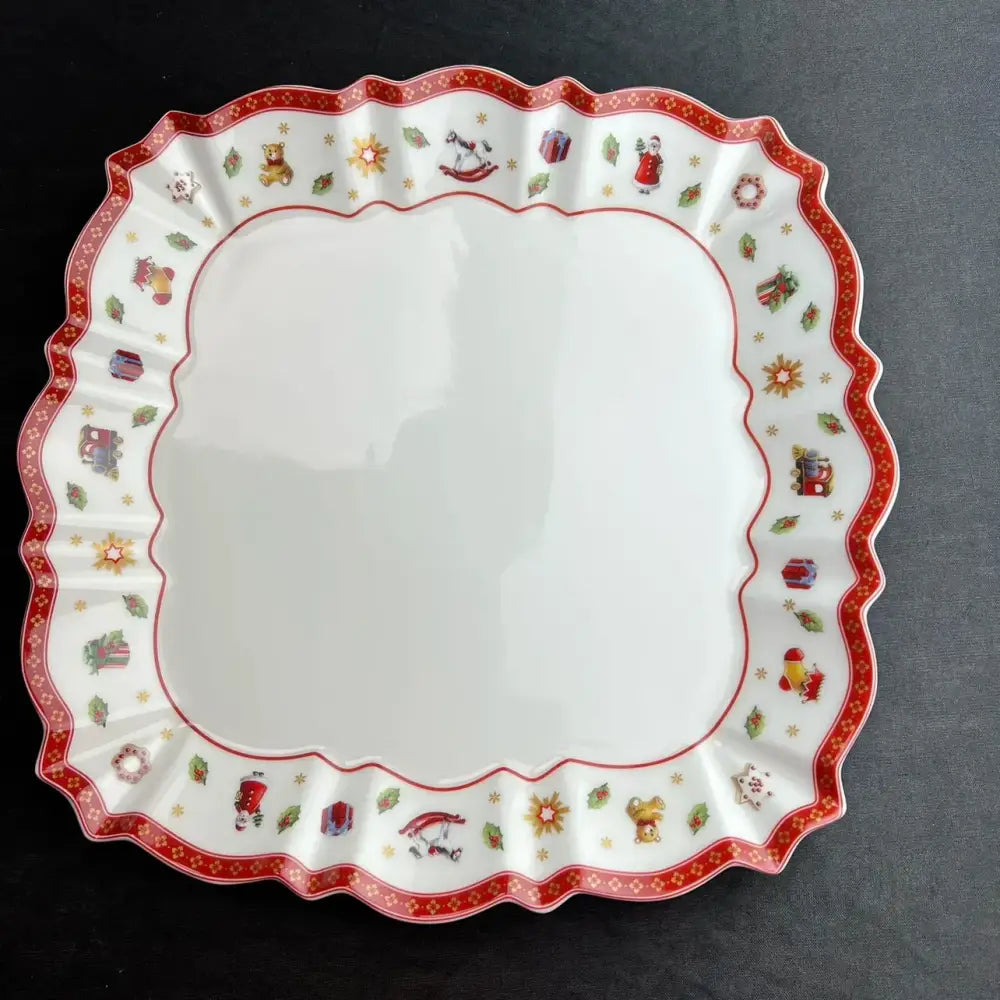 A festive white ceramic serving platter with scalloped edge featuring red and gold decorbites christmas porcelain tableware set designs