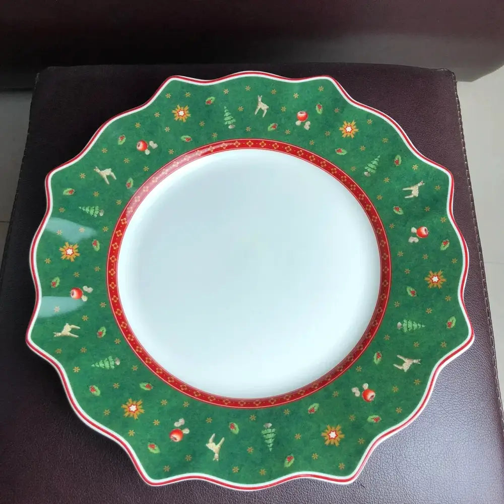 Green ceramic plate with scalloped edges and festive reindeer pattern from decorbites christmas porcelain tableware set