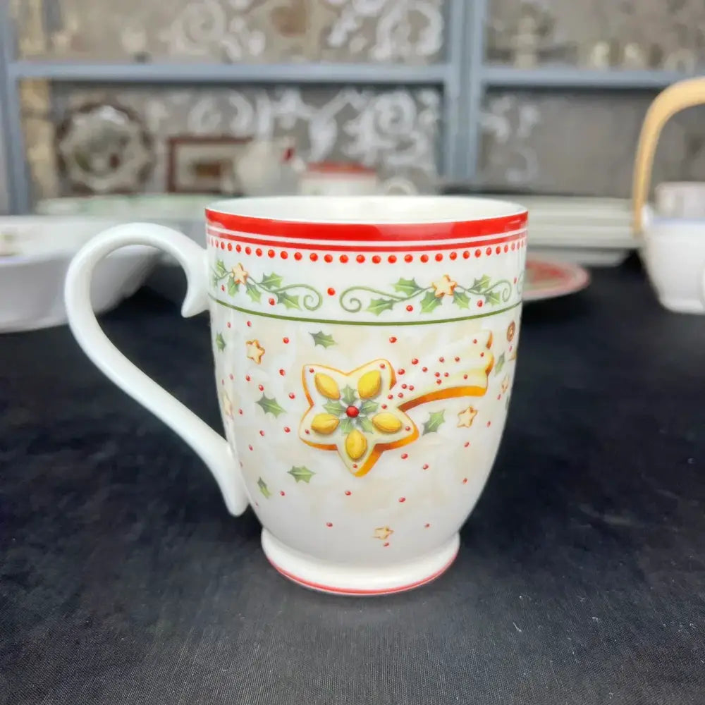 White ceramic mug with red and green gingerbread star design from decorbites christmas porcelain tableware set