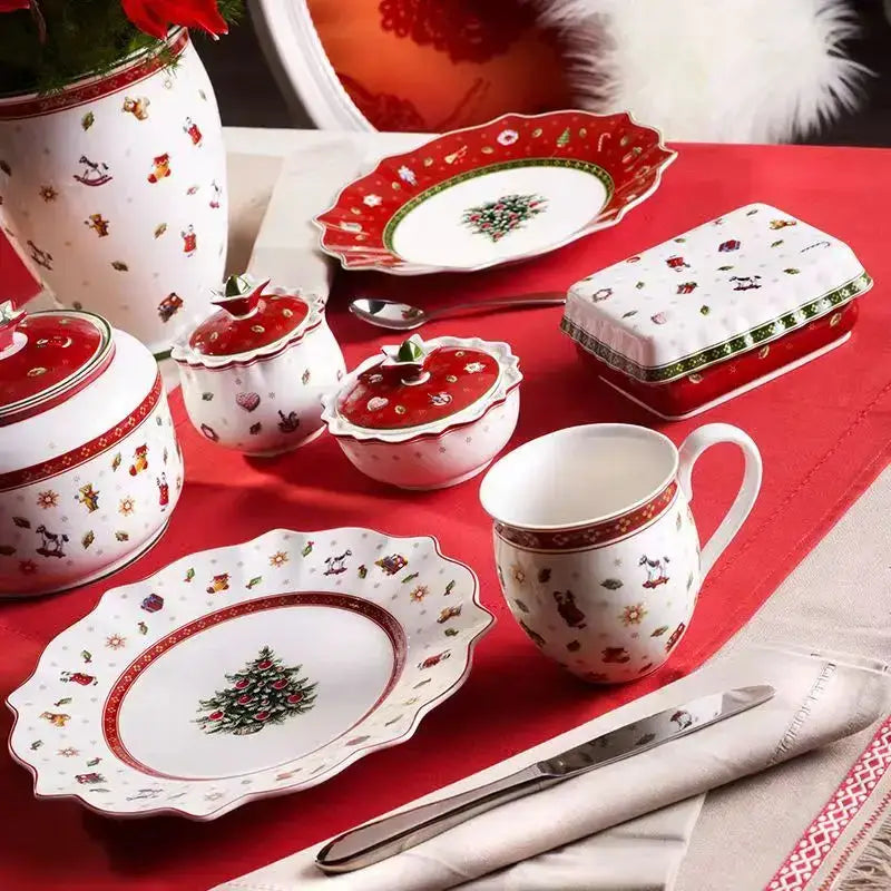 White ceramic christmas porcelain tableware set by decorbites with red accents and festive holiday illustrations
