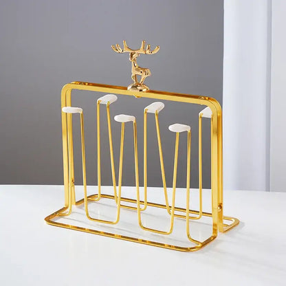Golden metal cups holder set with deer figurine and white ceramic accents for drying glass cups by decorbites