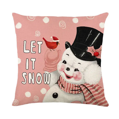 Pink linen pillow cover featuring a cheerful snowman with a black top hat and cardinal decorbites christmas santa design