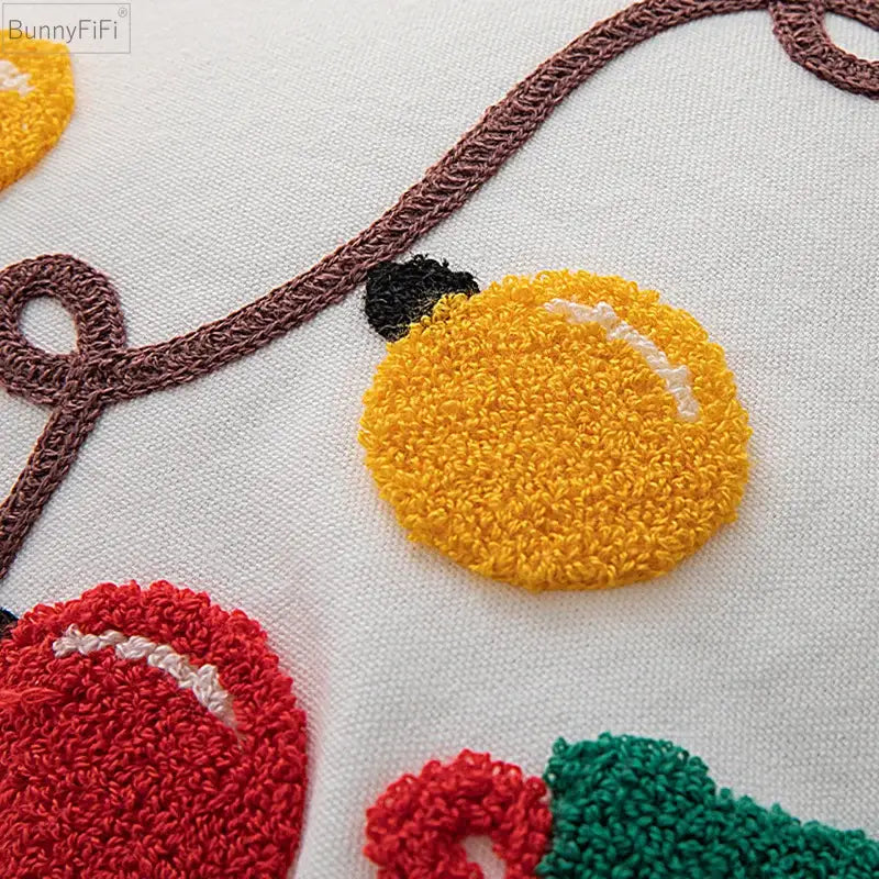 A vibrant pillow cover featuring embroidered yellow lemon with white stitching from decorbites christmas santa snowflake collection