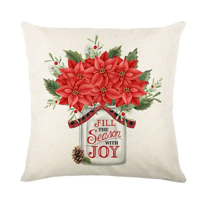 Beige linen pillow cover with red poinsettias in a mason jar and festive greenery by decorbites christmas snow elk