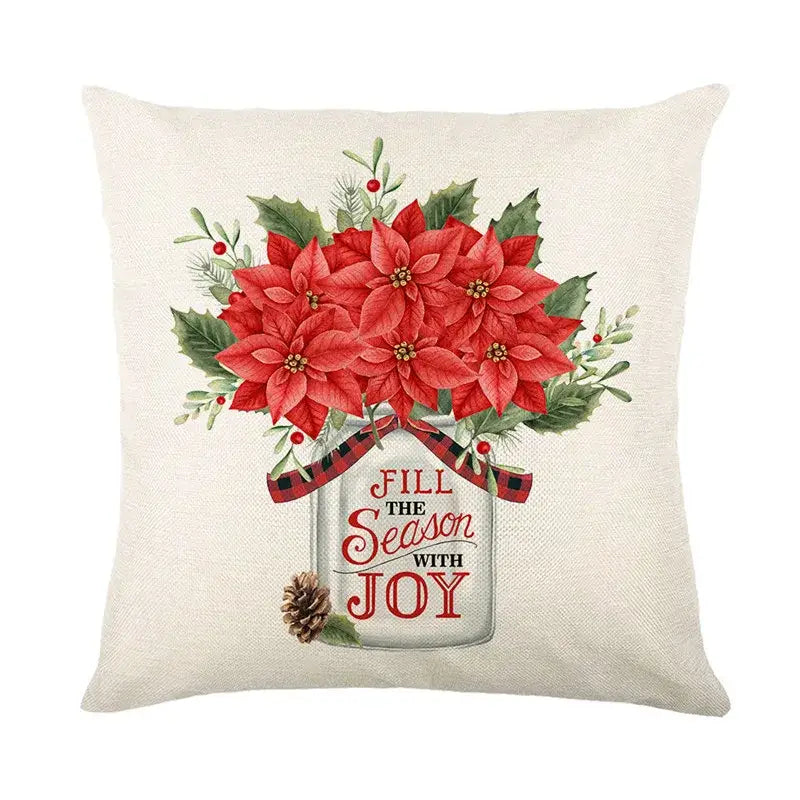 Beige linen pillow cover with red poinsettias in a mason jar and festive greenery by decorbites christmas snow elk