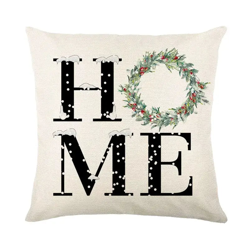 Beige linen pillow cover with black home text and green wreath design from decorbites christmas snow elk collection