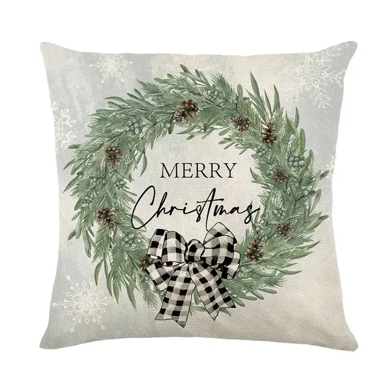 Beige pillow cover by DecorBites Christmas Snow featuring a green pine wreath with pinecones and a checkered bow
