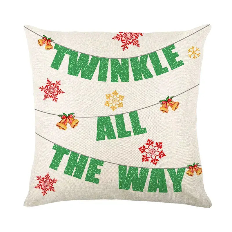 Cream-colored decorbites christmas snow elk pillow cover with glittery green text red and gold snowflakes and golden bells