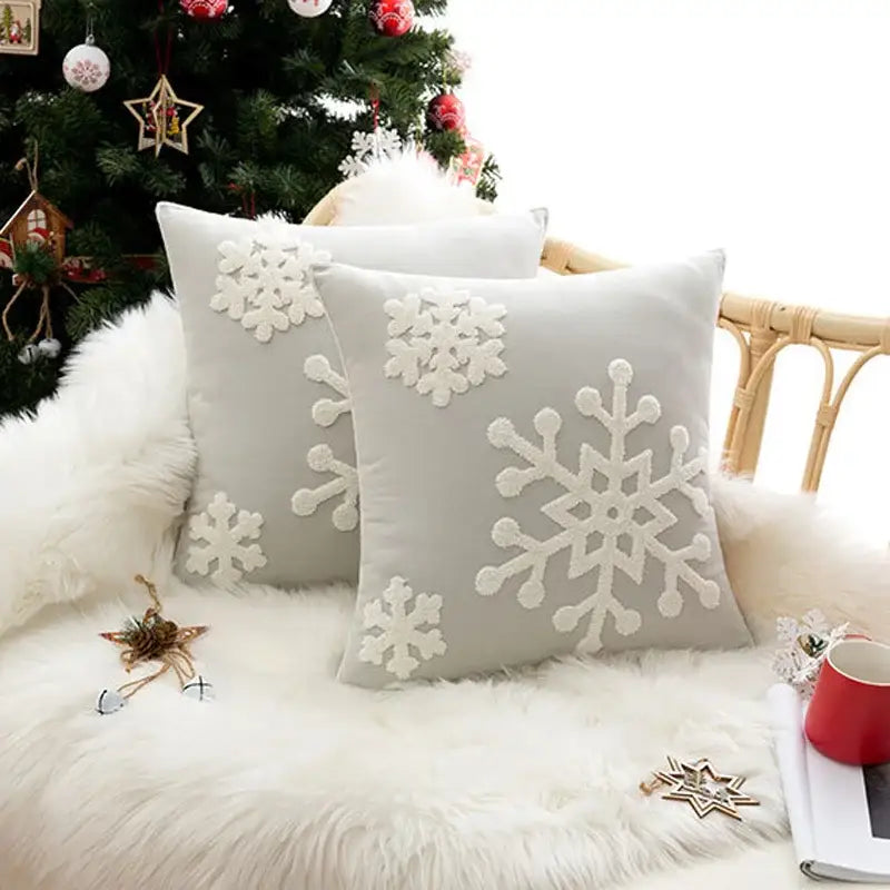 Soft gray cushion cover with embroidered white christmas snowflake design by DecorBites for home decor and parties