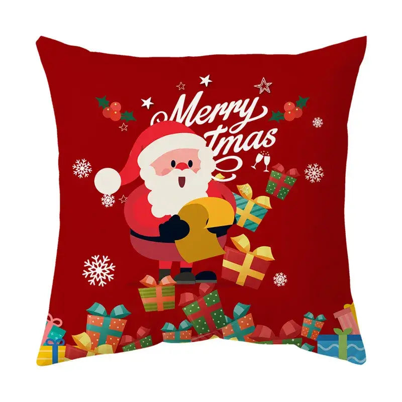 Red DecorBites Christmas sofa pillow cover featuring cartoon Santa, colorful gifts, snowflakes, holly, and merry xmas text