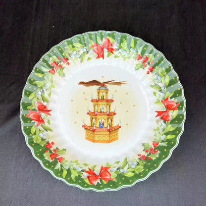 A festive ceramic plate from DecorBites Christmas tableware featuring a golden pagoda with red bows and holly berries