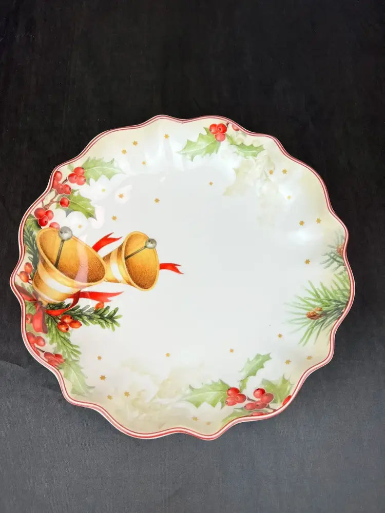 White ceramic serving bowl with scalloped edges and festive golden bells holly motifs from DecorBites Christmas tableware