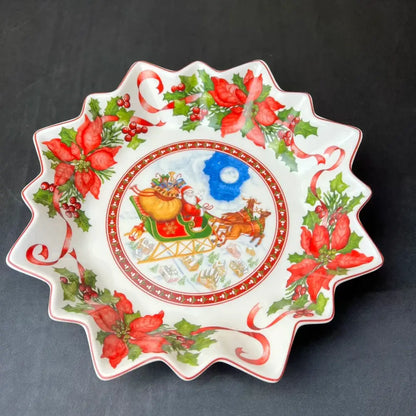 White ceramic christmas dish with scalloped edge featuring santa in sleigh and poinsettias for decorbites christmas tableware