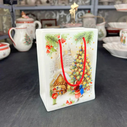 White ceramic gift bag with red handles and festive holiday illustrations from DecorBites Christmas tableware set