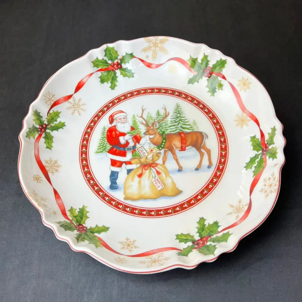 White ceramic christmas plate from decorbites christmas tableware featuring santa claus reindeer holly and gold snowflakes