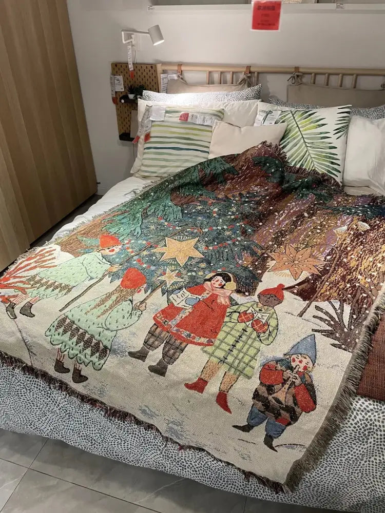 Decorbites christmas throw blanket featuring a textured festive scene with children and tree in red green gold cream tones